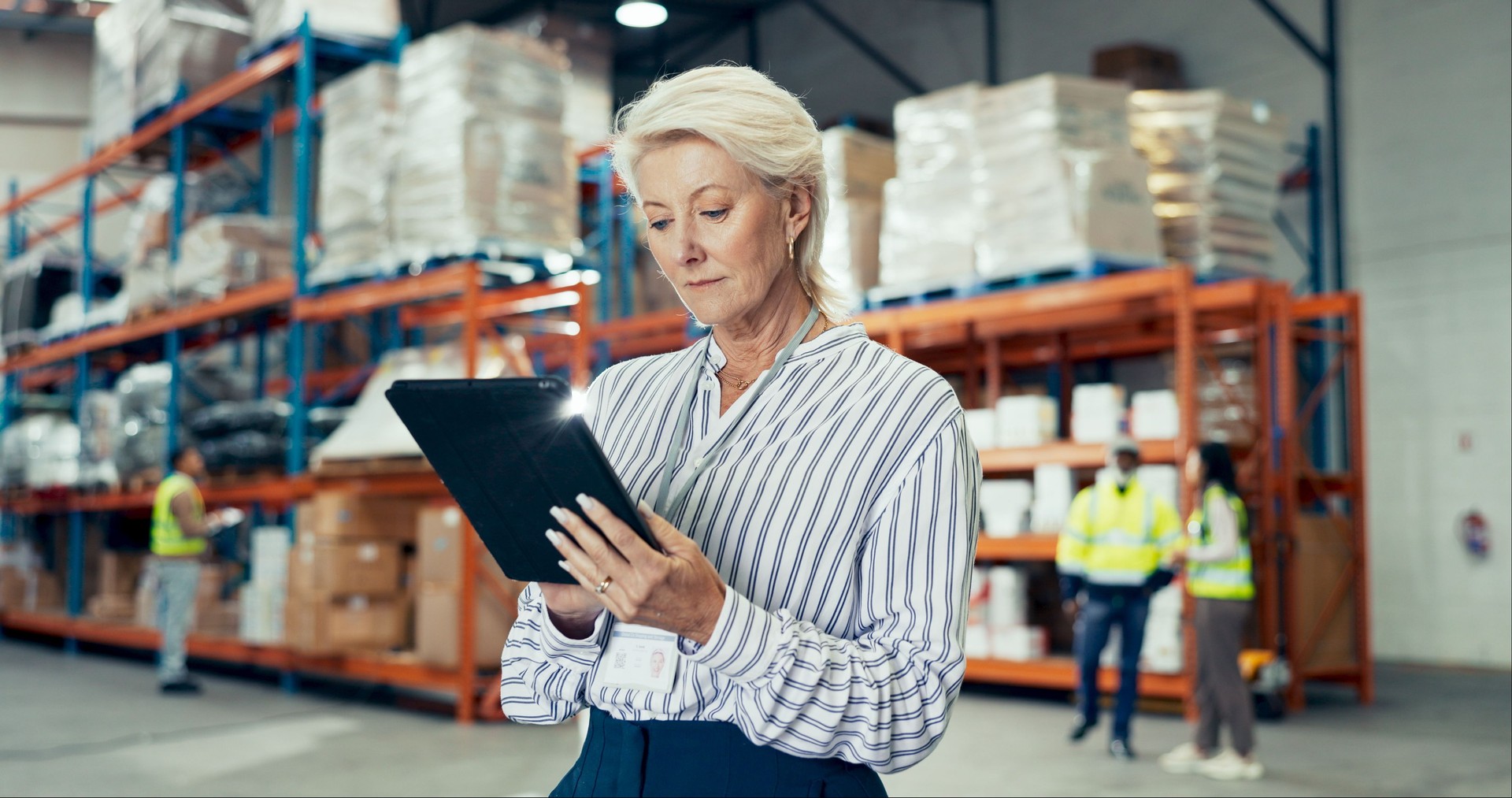 Logistic, mature woman and tablet for ecommerce in warehouse, quality control or stock management. Engineer, tech and maintenance in freight, supply chain or factory at shipping company as supervisor
